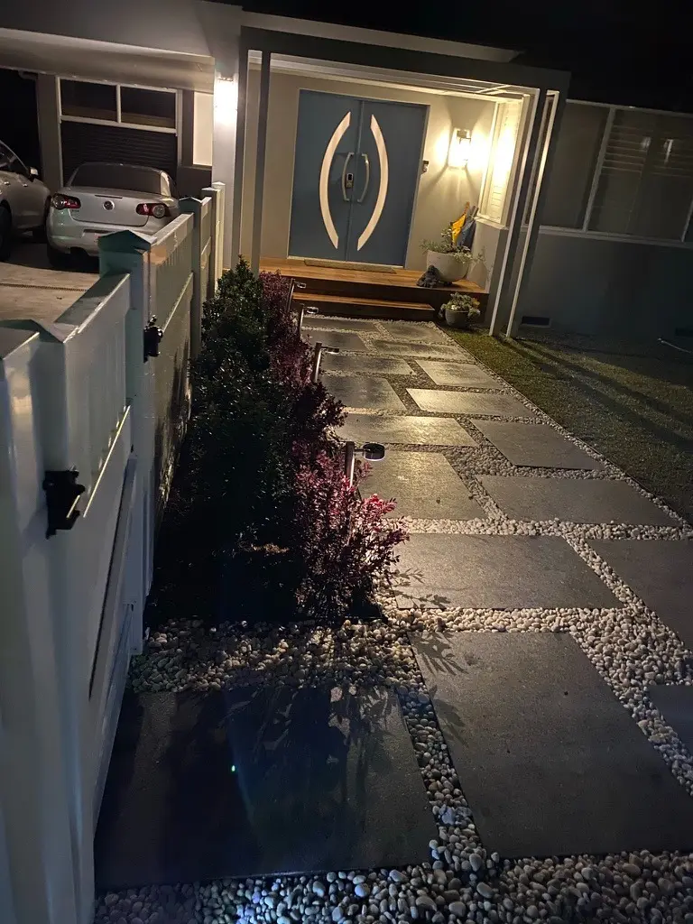 Refined entry pathway, fresh landscaping and modern exterior detailing